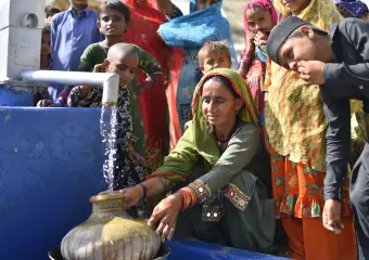 People handling rice bags and supplies